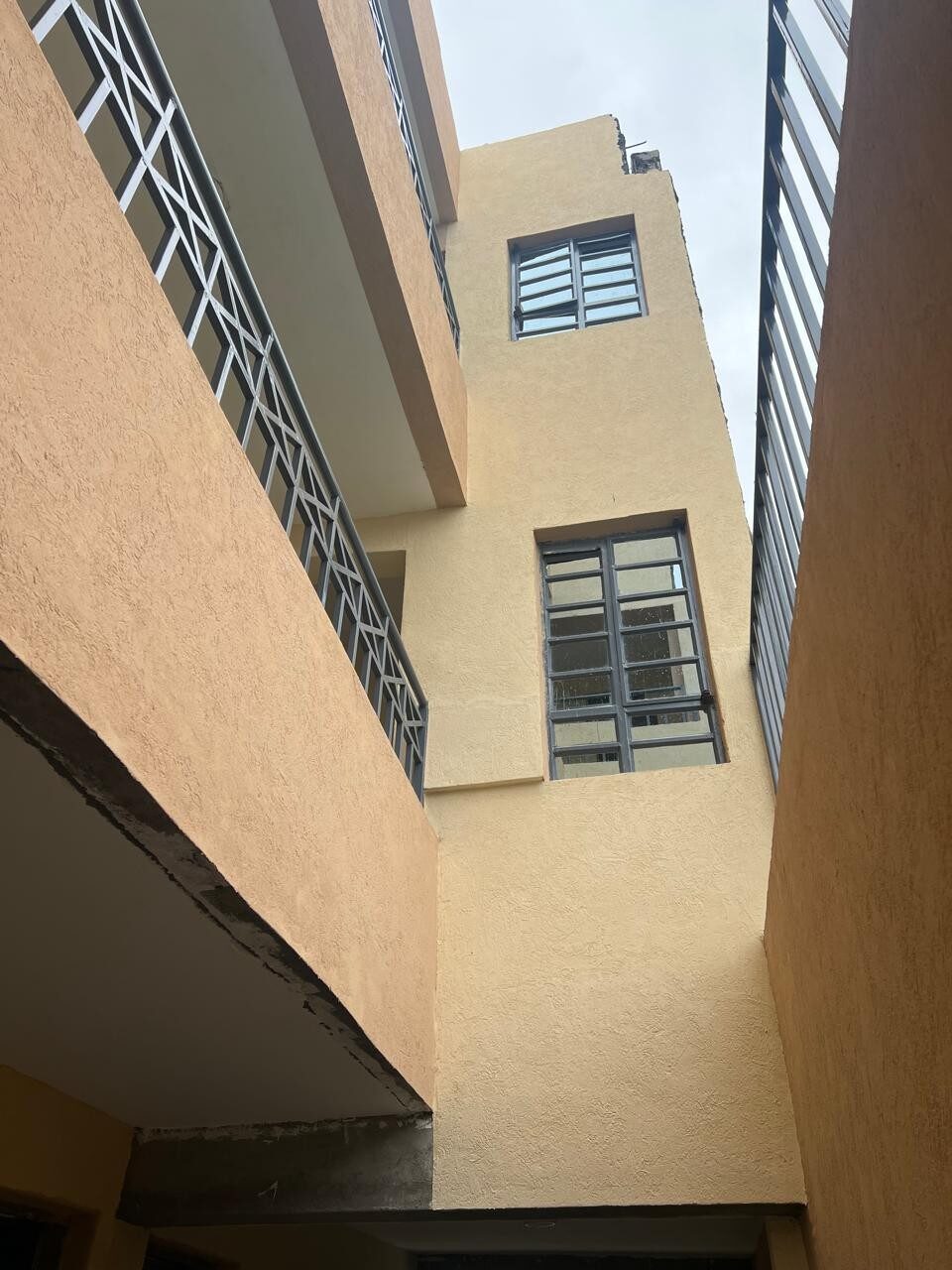 Low-angle view of the finished apartment exterior with metal railings