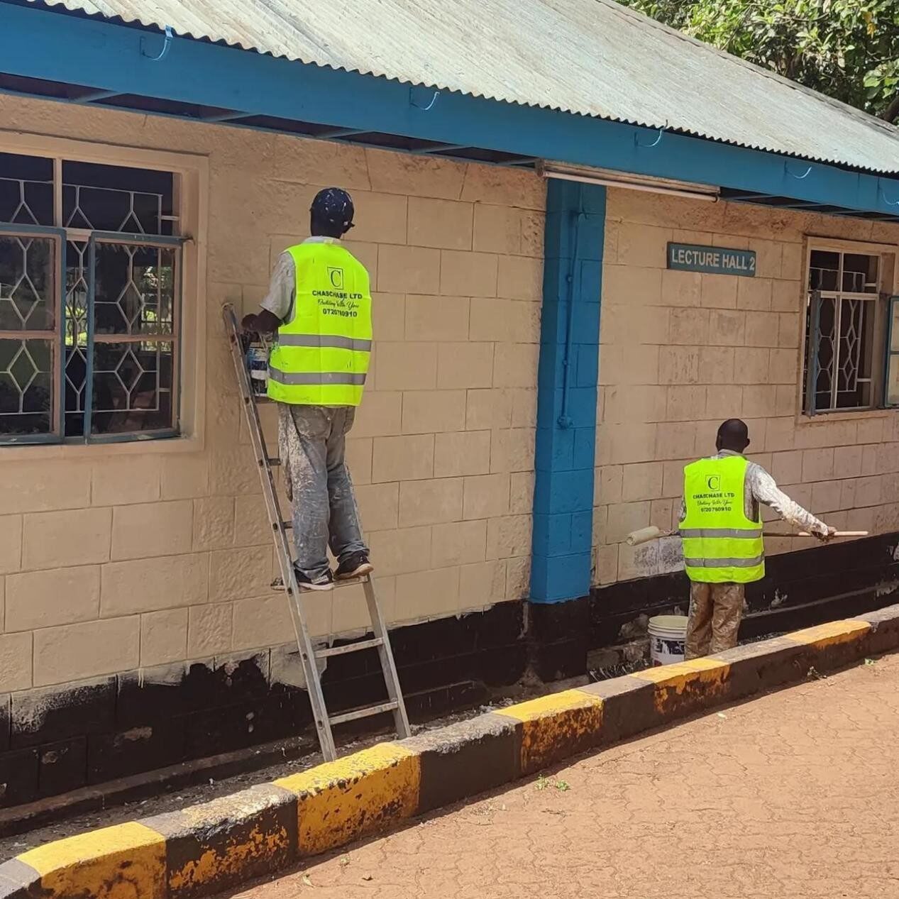 Chaschase team repainting a University of Nairobi lecture hall exterior